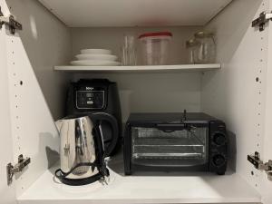 a small kitchen with a toaster oven and a toaster at Private Apartment for Business & Couples in Sudbury