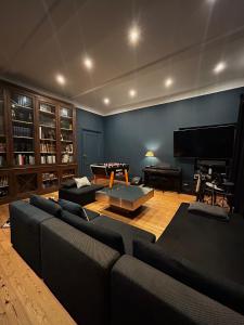 a living room with two couches and a piano at Château Bernon Gite 15 Personnes - piscine et SPA in Queyrac