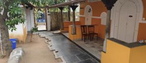 a room with a table and a chair in a house at Le Aham Boutique Hotel in Kuilapayam
