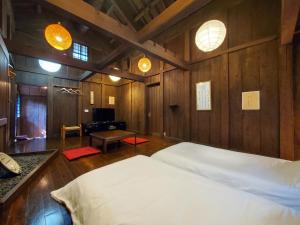 a bedroom with a bed and a living room at shoya yamaguchi in Koibuchi