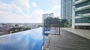 a swimming pool on the roof of a building at Grand Kamala Lagoon by Whitebox in Bekasi