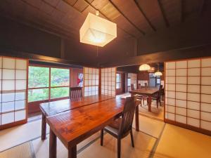a dining room with a wooden table and chairs at shoya yamaguchi in Koibuchi +40 photos