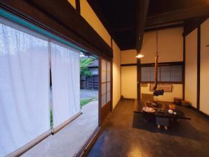 a room with a large window and a table at shoya yamaguchi in Koibuchi