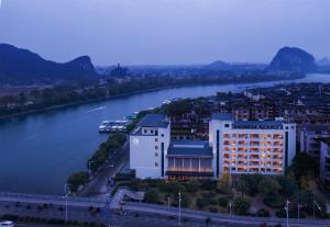 arial view of a building next to a river at GUILIN LI RIVER CIAO Hotel in Guilin