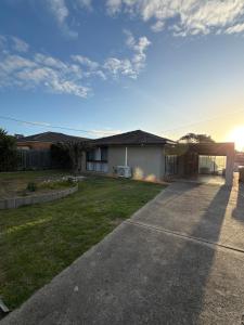 a house with a driveway in front of a yard at Weekend Escape in Rosebud +6 photos