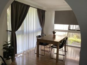 a dining room with a table and chairs and a window at Weekend Escape in Rosebud