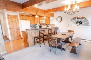 a kitchen and dining room with a table and chairs at Snowmass 2br Getaway Pool, Hot Tub & Ski Access - D2 in Snowmass Village