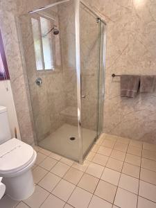 a shower with a glass door in a bathroom at Warragul Views Motor Inn in Warragul