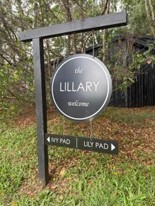 a sign for the library in a park at Lily Pad Tiny Home in Maleny