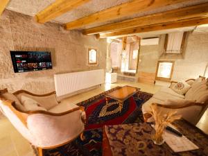 a large living room with couches and a table at My Cave Suites in Nevşehir