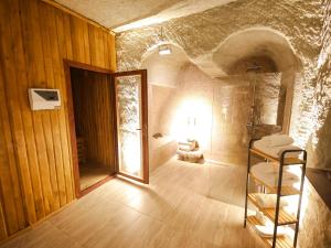 a bathroom with a walk in shower and a mirror at My Cave Suites in Nevşehir