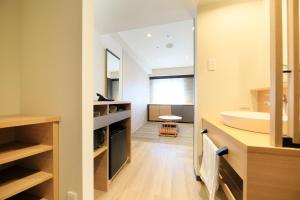 a bathroom with a sink and a mirror at Richmond Hotel Matsumoto in Matsumoto