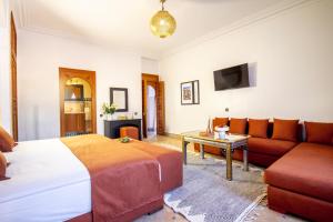 a hotel room with a bed and a couch at Riad Zaki Marrakech in Marrakesh