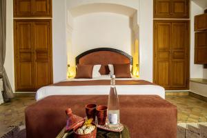 a hotel room with a large bed with a tray of food at Riad Zaki Marrakech in Marrakesh