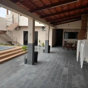 a large patio with a table and stairs in a building at Pousada-Suítes Alto do Moura in Caruaru