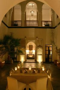 Habitación grande con una mesa con velas. en Dar Seven, en Marrakech