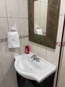 a bathroom with a white sink and a mirror at Loft 1 with 2 beds near Fundidora and Cintermex in Monterrey +16 photos