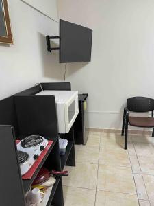 a kitchen with a microwave oven and a stove at Loft 1 with 2 beds near Fundidora and Cintermex in Monterrey