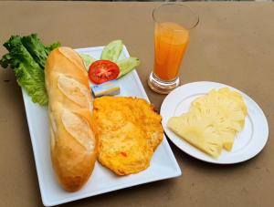 a plate of food with a sandwich and cheese and a drink at Tam Coc Eco Field Nest By ANMS GROUP in Ninh Binh +72 photos