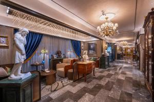 a hotel lobby with a statue of a woman at Orange Crystal Hotel Yantai Binhai Square in Yantai