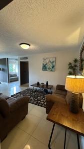 a living room with a couch and a table at Jaco Beach Penthouse in Jacó