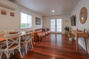 a living room with a couch and a table at Bungalow Blue - 8 Illawong Lane in Evans Head