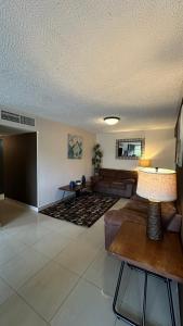 a living room with a couch and a table at Jaco Beach Penthouse in Jacó
