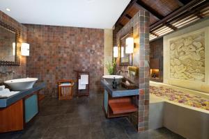 a bathroom with two sinks and a large tub and a tub at Villa Ambiente by Nakula in Jimbaran