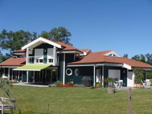 a large house with a green at Entre montagnes et lac in Armoy