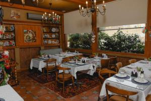 a dining room with white tables and chairs at Royal Historical Boutique Hotel in Baku
