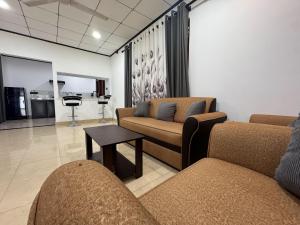 a living room with two couches and a table at Thousand Sunny Villa in Duwegoda