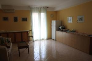 a kitchen with a refrigerator and a table in it at Garden House in Pozzallo