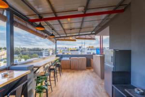 a bar with tables and chairs in a building at Loop by Zolo HSR Layout, Bangalore in Bangalore