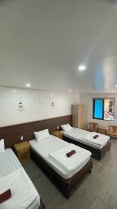 a room with three beds in it at Catba Chilling House Pool & Bar in Cat Ba