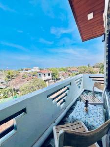 a balcony with chairs and a view of the city at Rehan Sunset Villa in Negombo