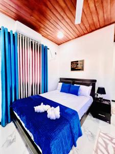 a bedroom with a bed with towels on it at Rehan Sunset Villa in Negombo