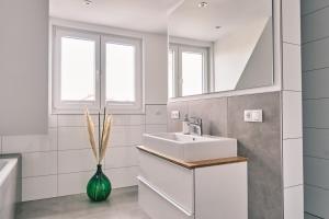 a bathroom with a sink and a mirror at Hotel 'Zum Augarten' in Speyer +66 photos