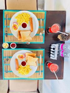 a table with two plates of food with eggs and toast at Bebe peak weligama in Weligama