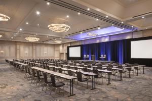 a conference room with tables and chairs and a screen at Grand Hyatt Atlanta in Buckhead in Atlanta +127 photos