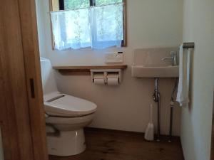 a bathroom with a toilet and a sink and a window at ゲストハウス山音 in Takayama +24 photos