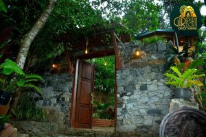 an entrance to a stone building with a wooden door at Giripura Resort - Kandy in Kandy
