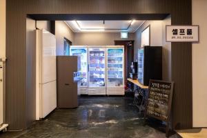 a store with refrigerators and a sign in a room at 달빛소리호텔 in Ajung-yŏk +76 photos