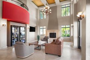 a living room with couches and a fireplace at Ramada Suites by Wyndham San Diego Hotel Circle Area in San Diego