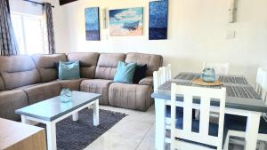a living room with a couch and a table at Chakas Rock Chalet 39 in Ballito