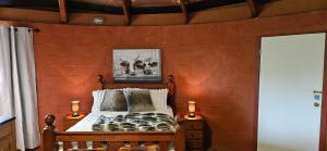 a bedroom with a wooden wall with a bed at Rileysview in Kilcoy