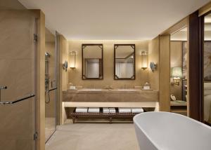 a bathroom with a large sink and two mirrors at Renaissance Goa Hotel in Goa +76 photos