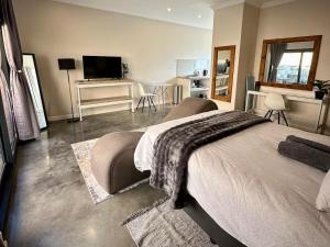 a bedroom with a bed with a blanket on it at Fern Rivers Self-Catering Accommodation in Pietermaritzburg