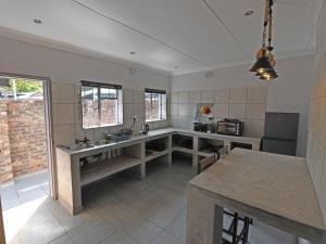 a kitchen with a sink and a counter top at Soliha Guesthouse in Trichardt