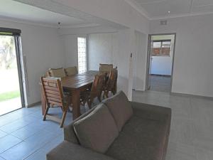 a living room with a table and chairs and a couch at Soliha Guesthouse in Trichardt +47 photos