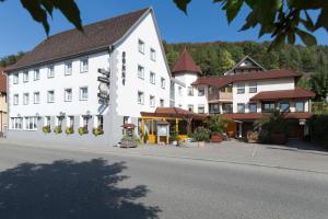 a large white building on the side of a street at Hotel Gasthof Sonne in Fridingen an der Donau